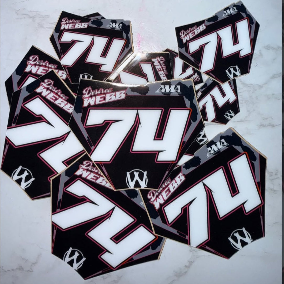 Multiple motorcycle decals with the number 74 and brand name on a dark background. mini