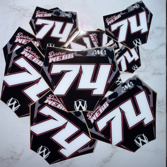 Multiple motorcycle decals with the number 74 and brand name on a dark background. mini